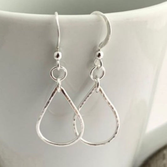 Sterling silver teardrop earrings on a white surface