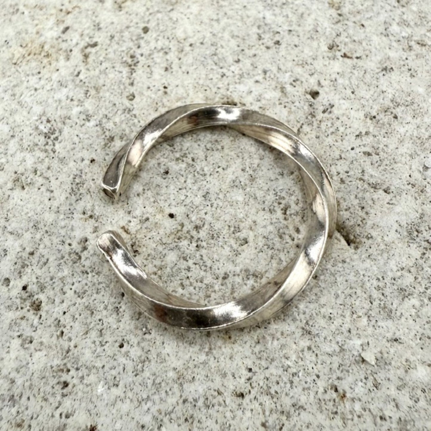 925 sterling Silver twisted ring on a natural stone surface
