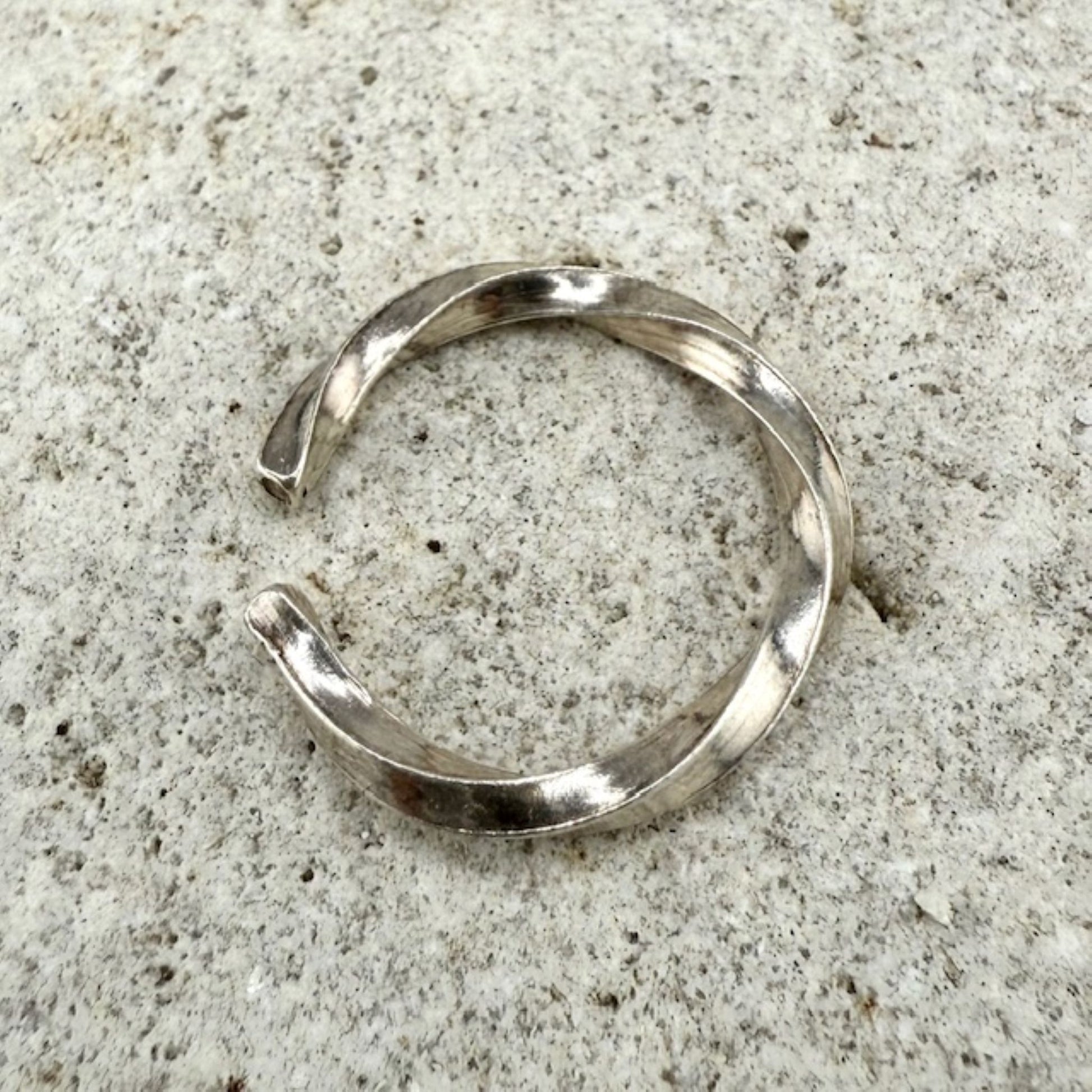 925 sterling Silver twisted ring on a natural stone surface