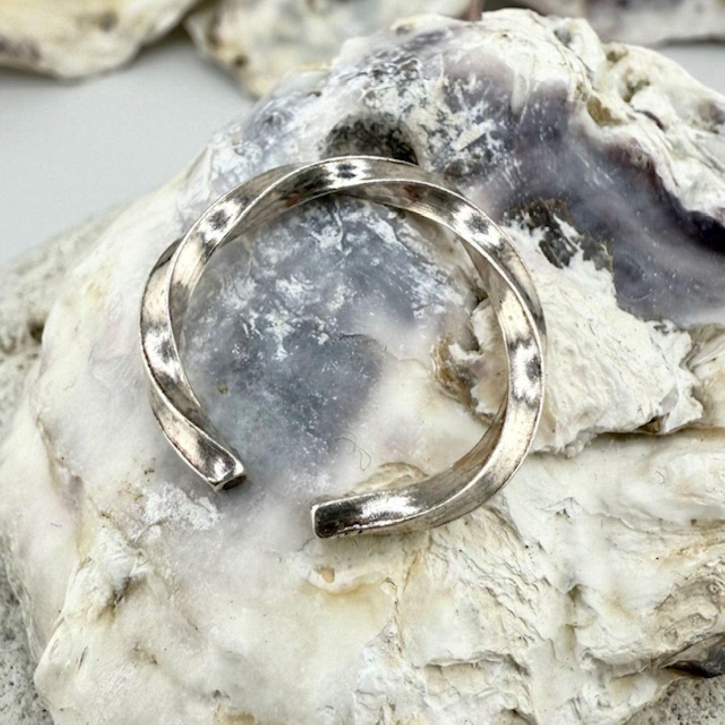 Silver ring on a textured stone surface