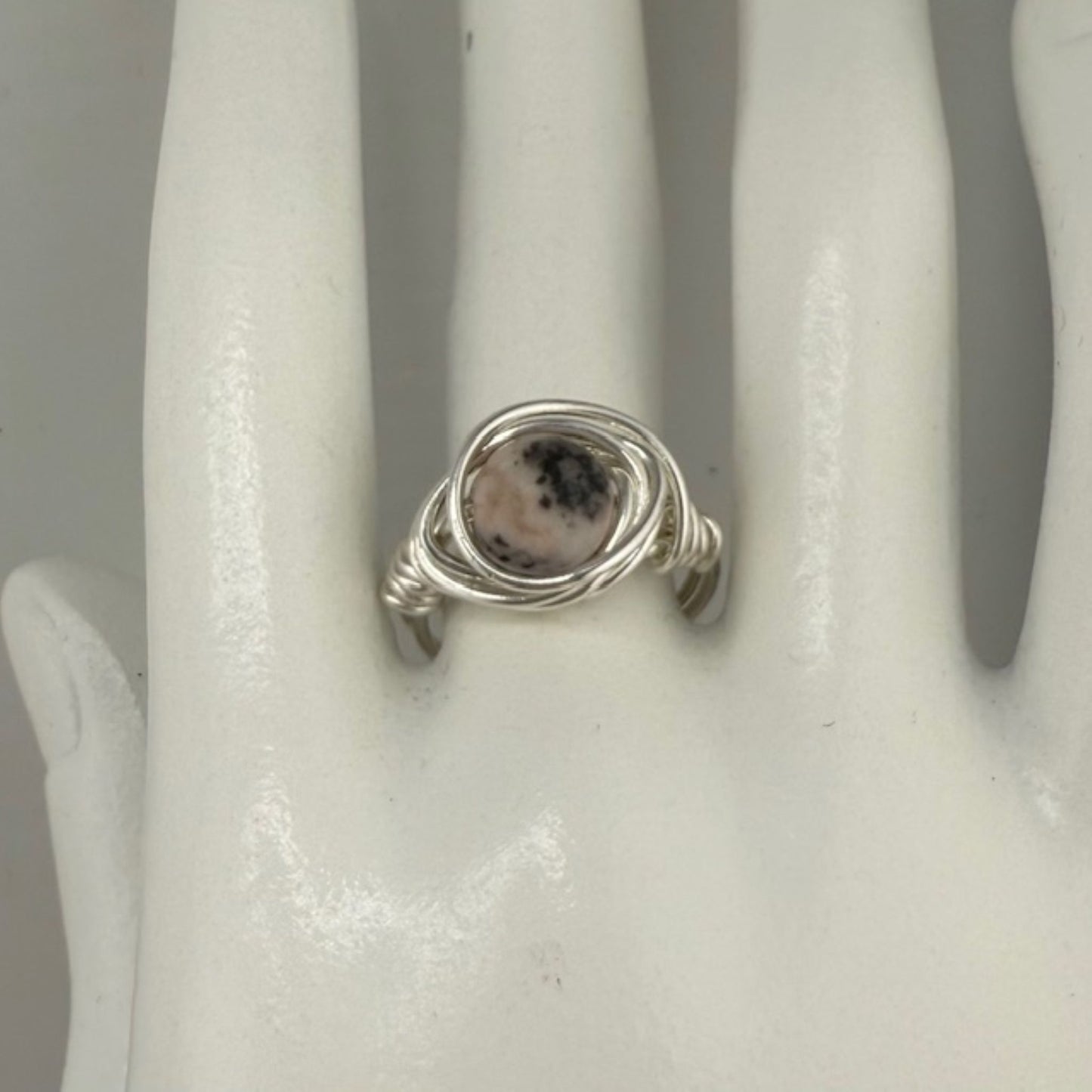 Silver ring with a jasper gemstone on a white mannequin hand