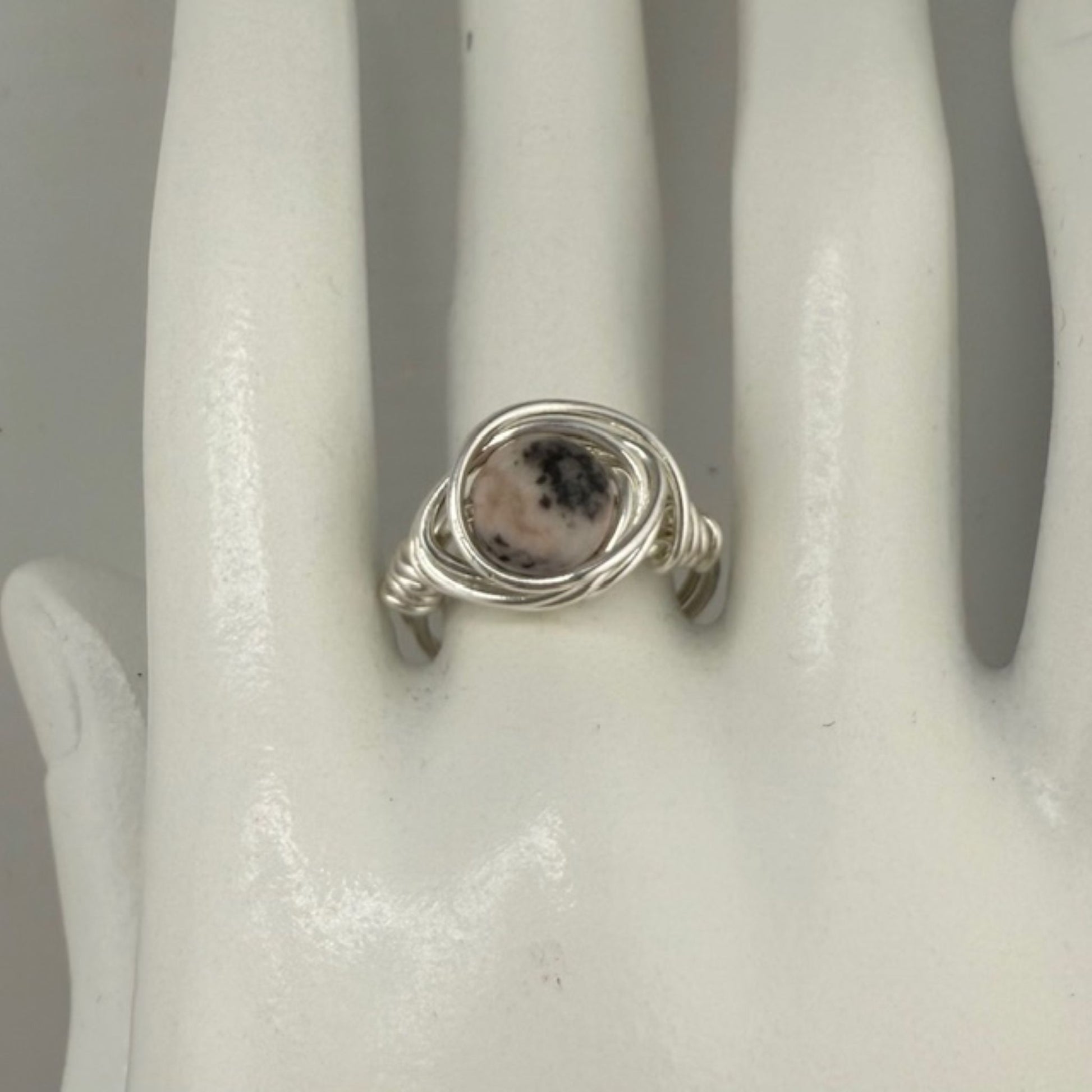 Silver ring with a jasper gemstone on a white mannequin hand