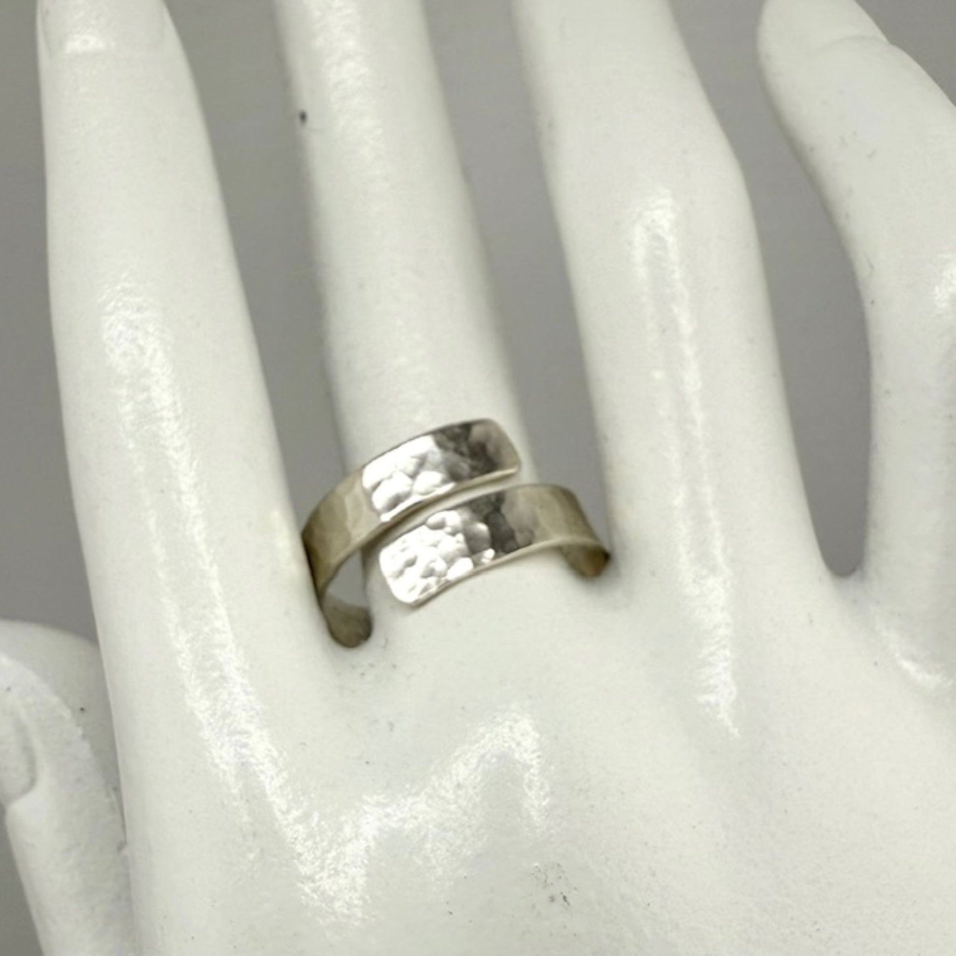 Silver ring on a white mannequin hand