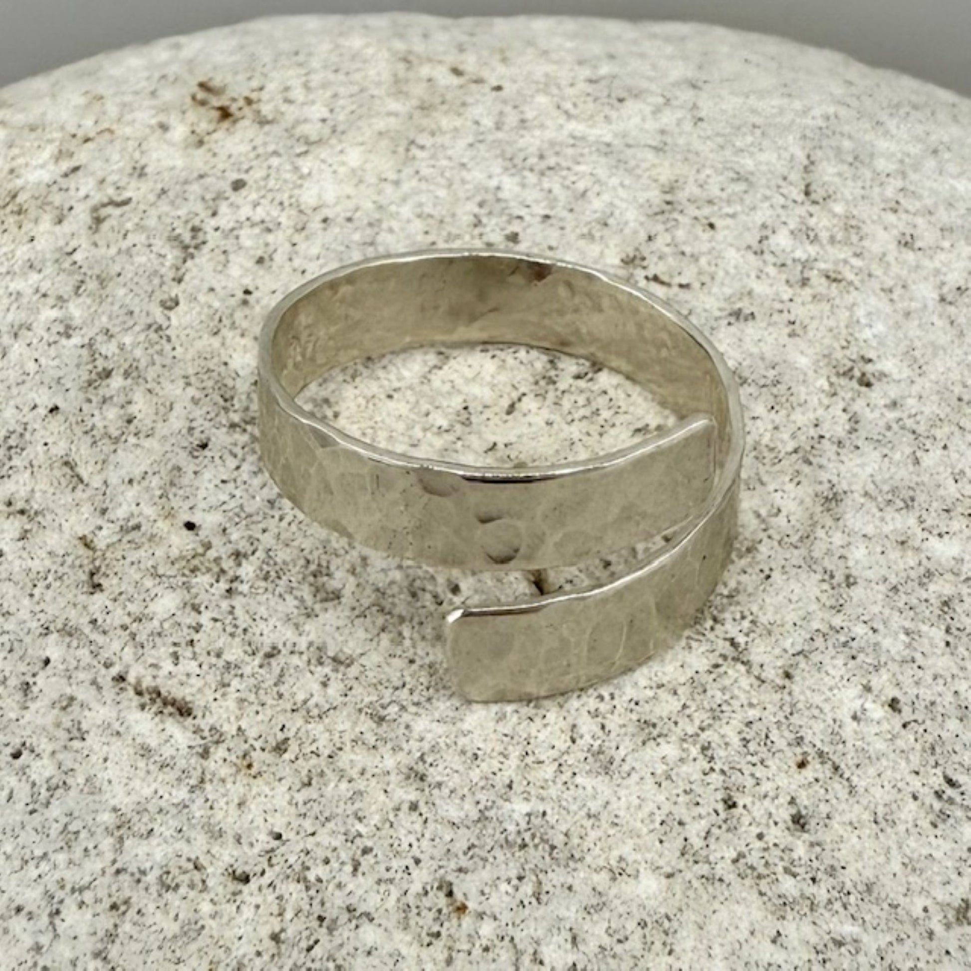 Silver ring on a textured stone surface