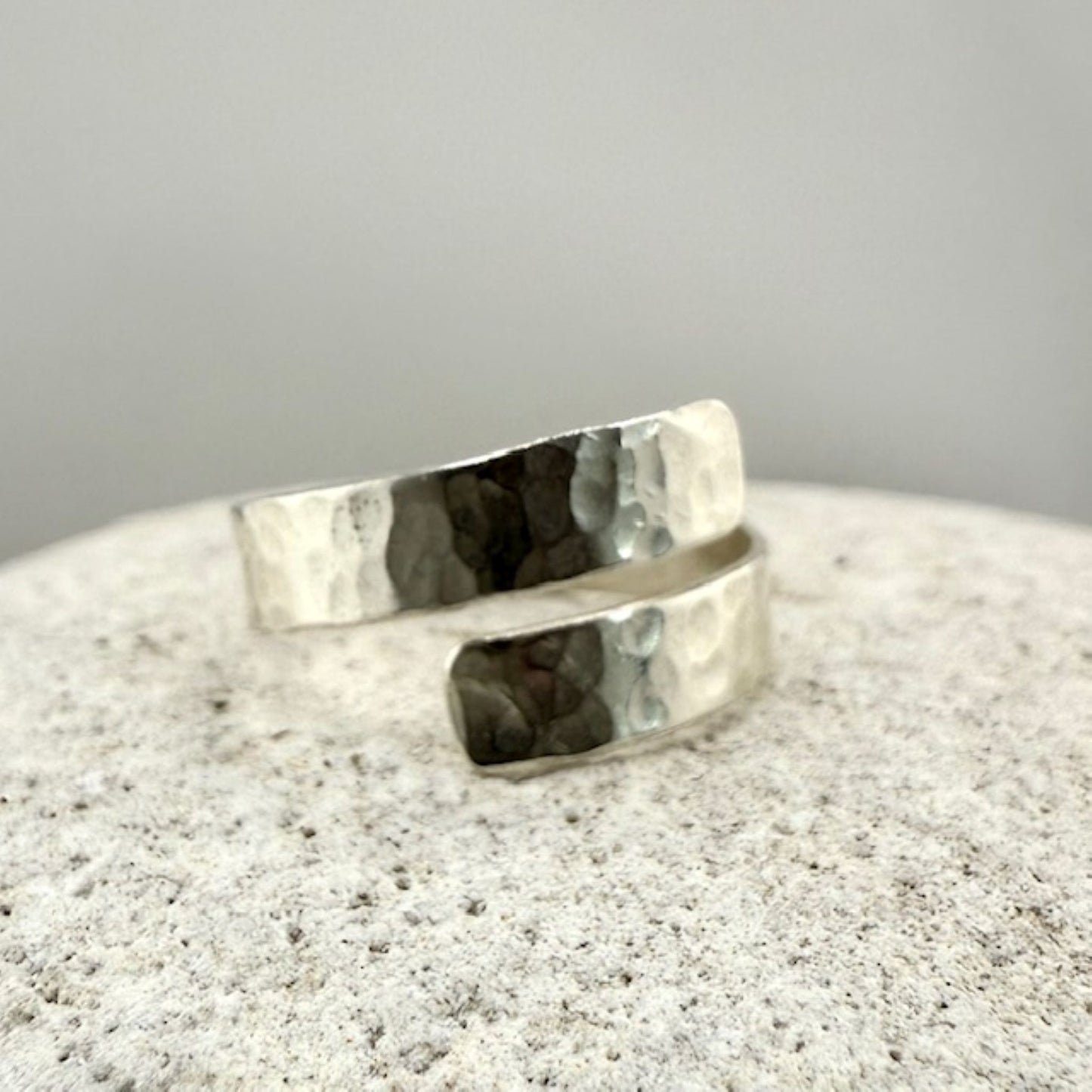 Silver ring on a textured natural stone  surface