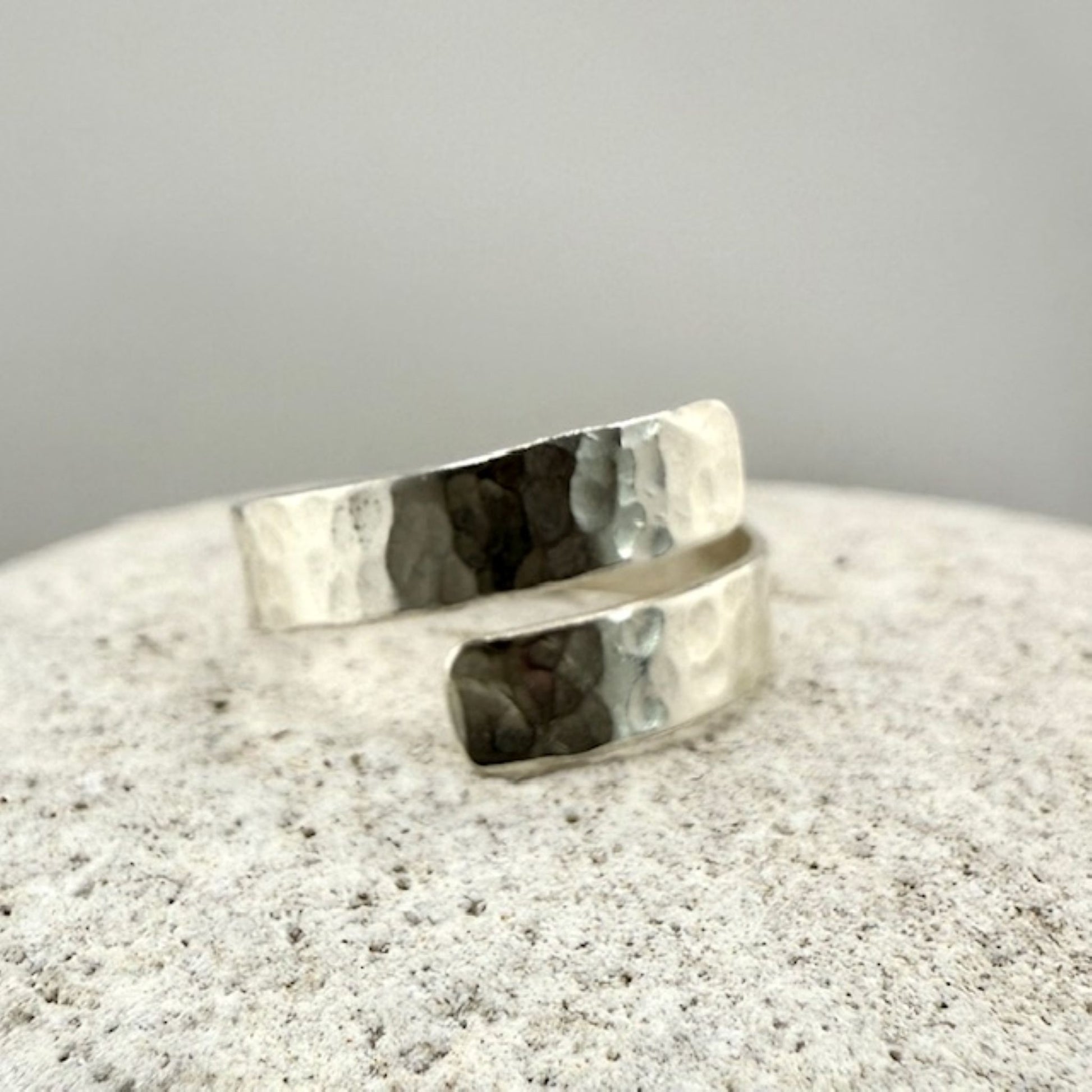 Silver ring on a textured natural stone  surface