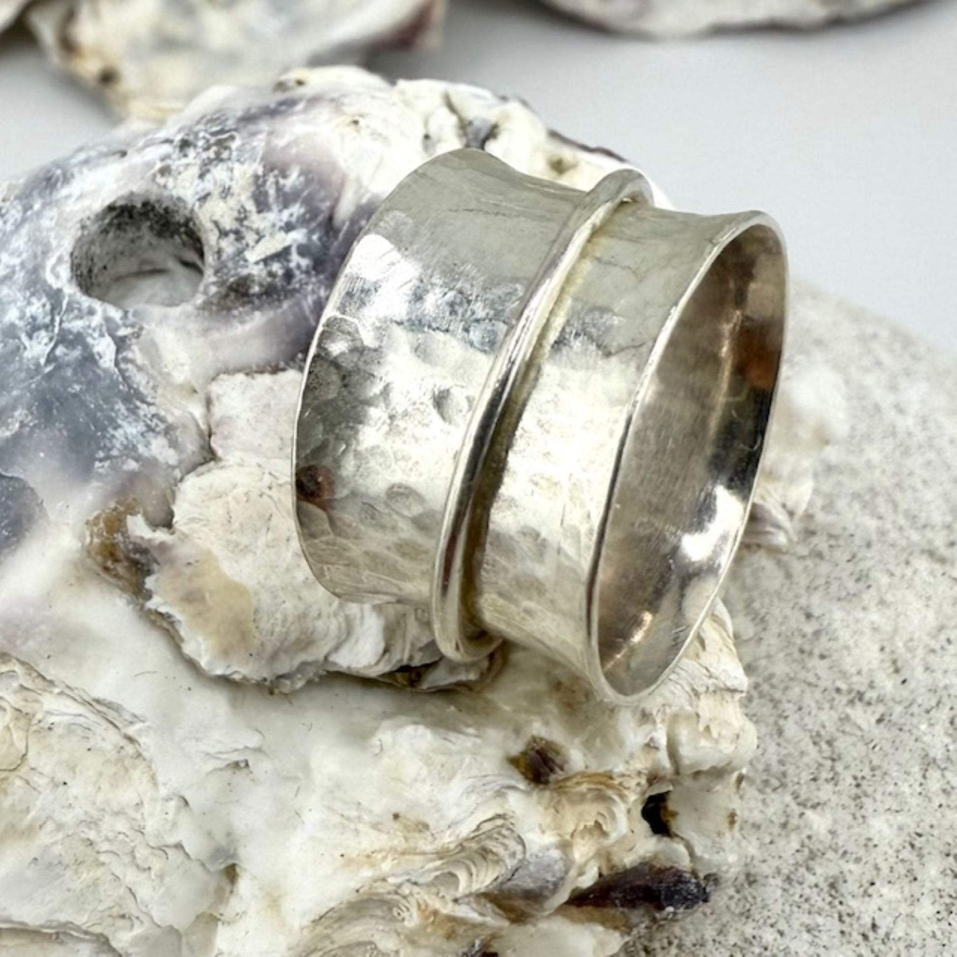 Silver spinner ring on a textured surface